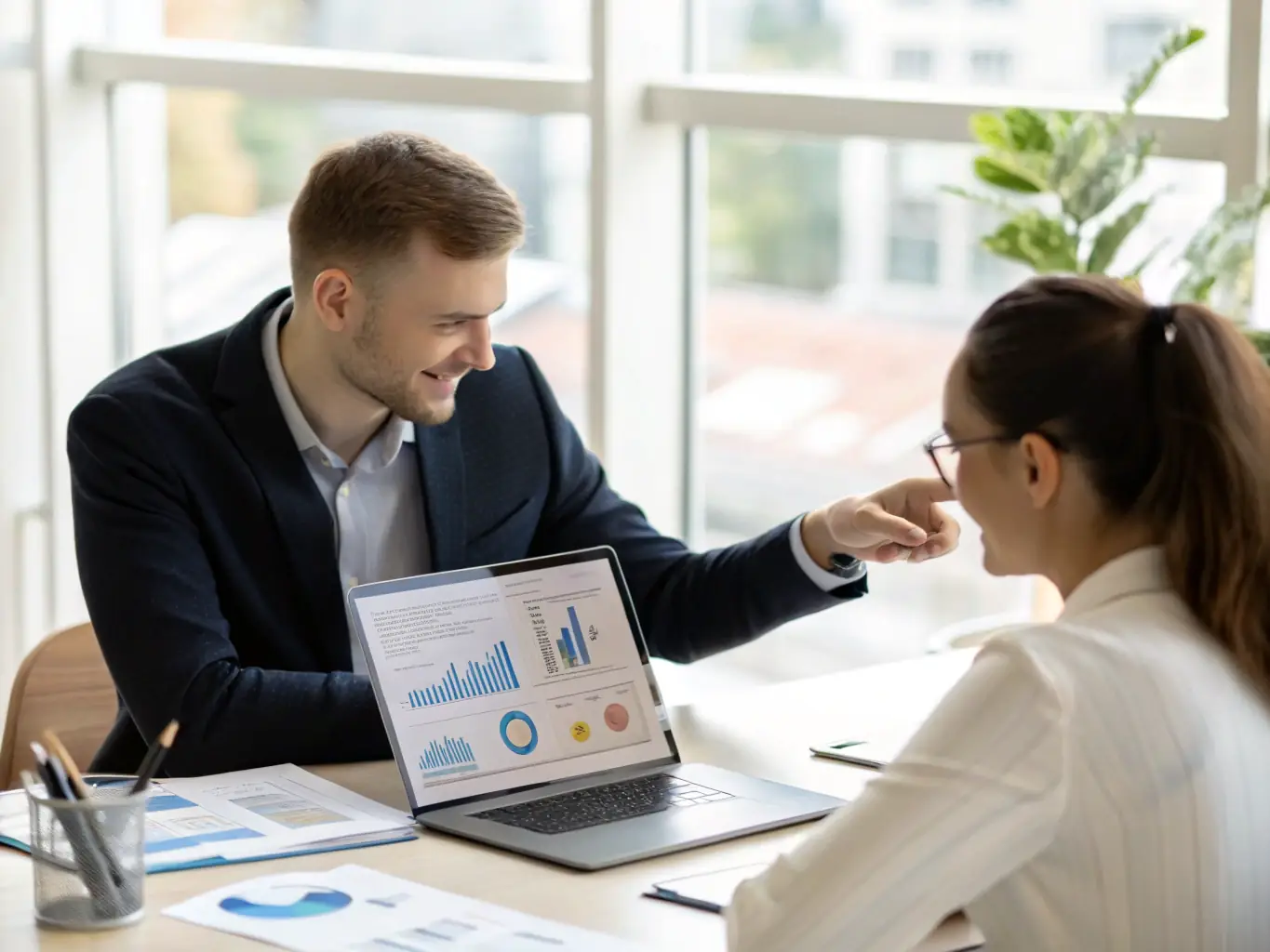 A professional business coach is guiding a SME owner through a strategic planning session, with visual aids like charts and graphs displayed on a screen in the background.